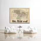 a large framed map of a city hanging on a white wall, with two white bean bag chairs positioned in front of it.