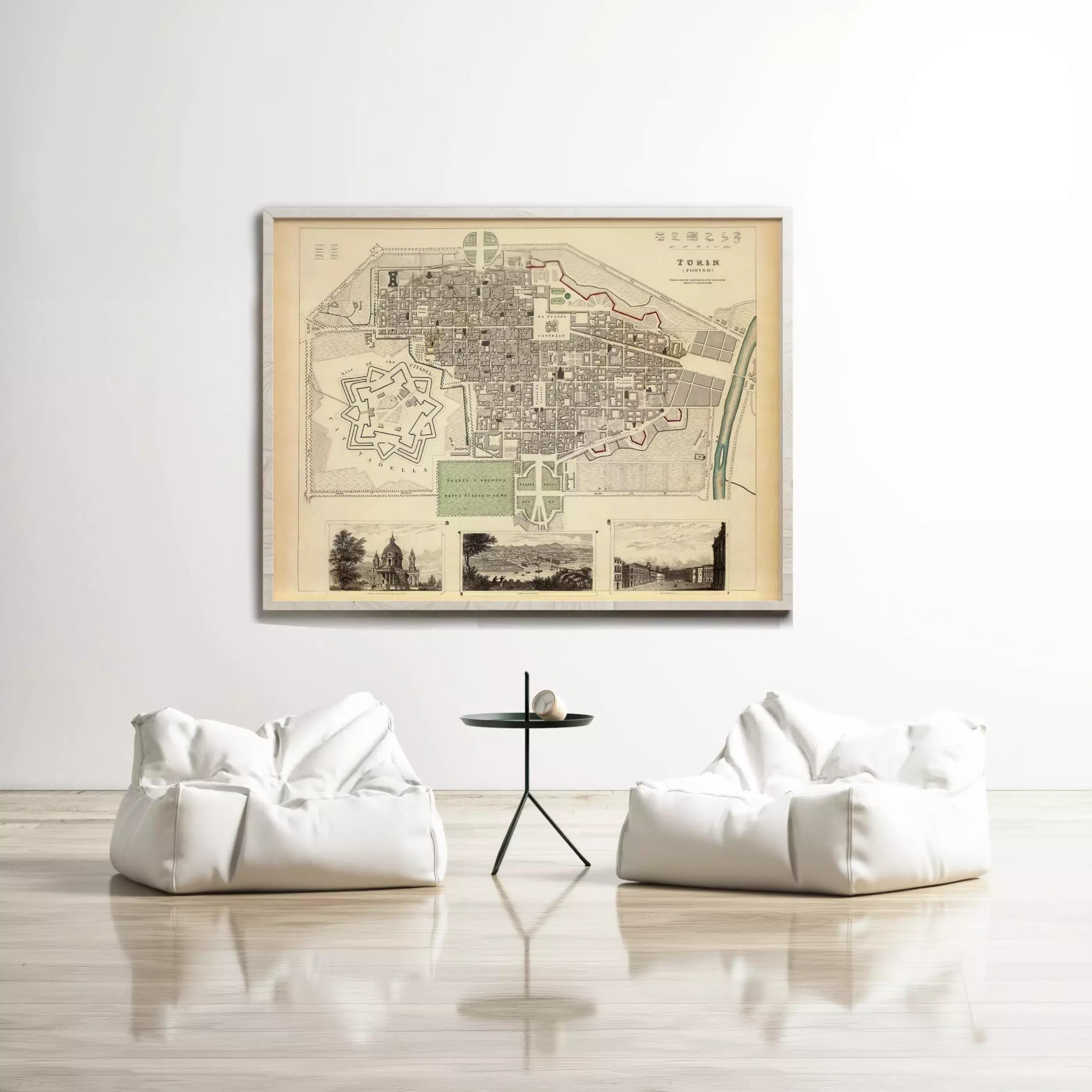 a large framed map of a city hanging on a white wall, with two white bean bag chairs positioned in front of it.