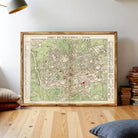 The image is a framed vintage map of London, England, with a green and red color scheme.