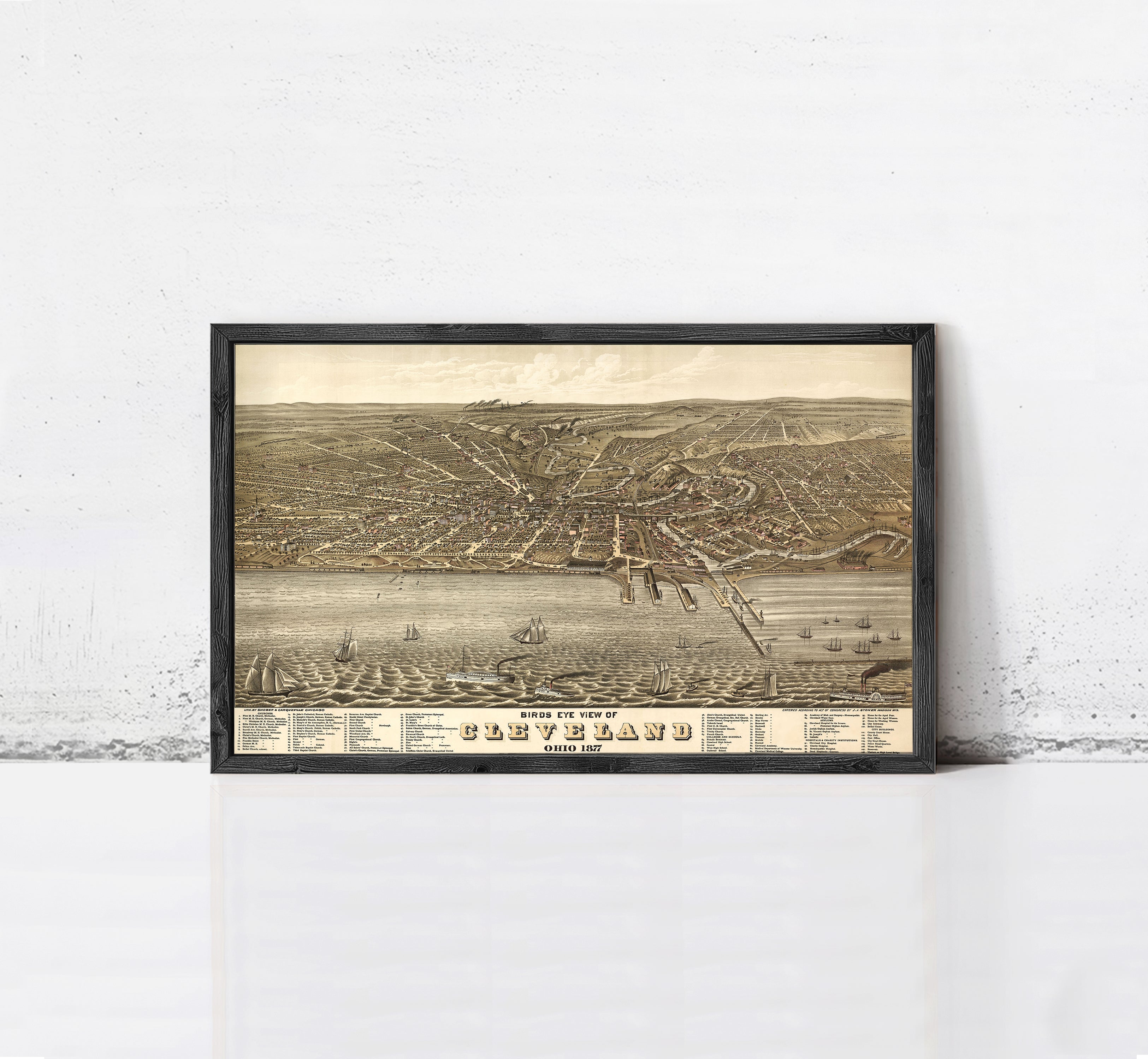 The image is a framed vintage map of Cleveland, Ohio, depicting the city's layout and surrounding areas.