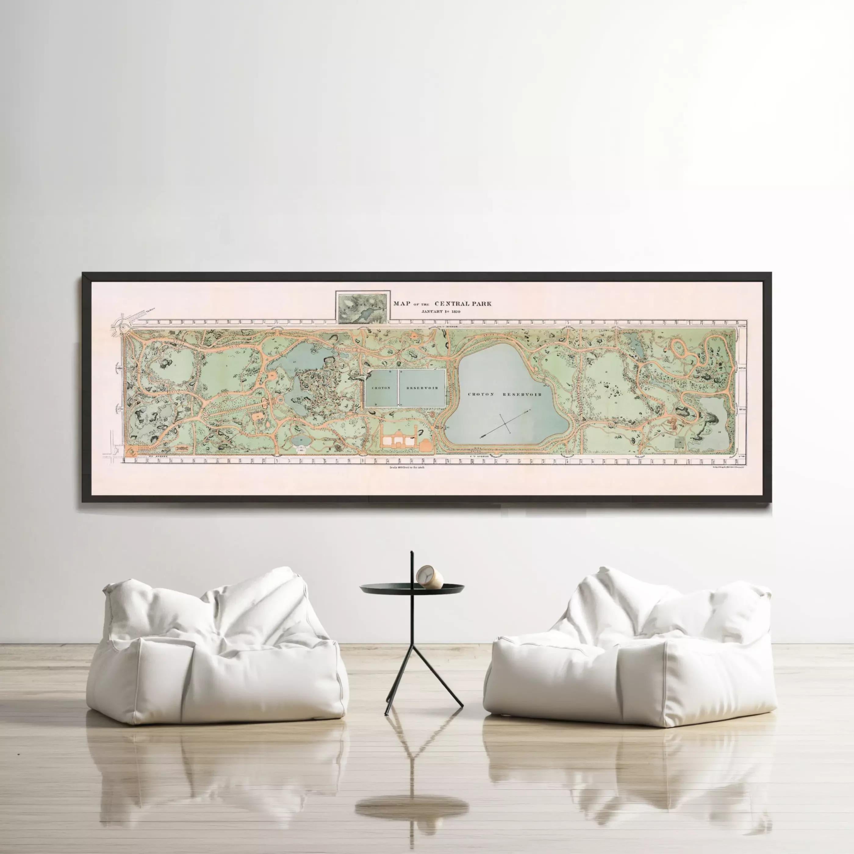 a large framed map of Central Park hanging on a wall, with two white bean bag chairs positioned in front of it.