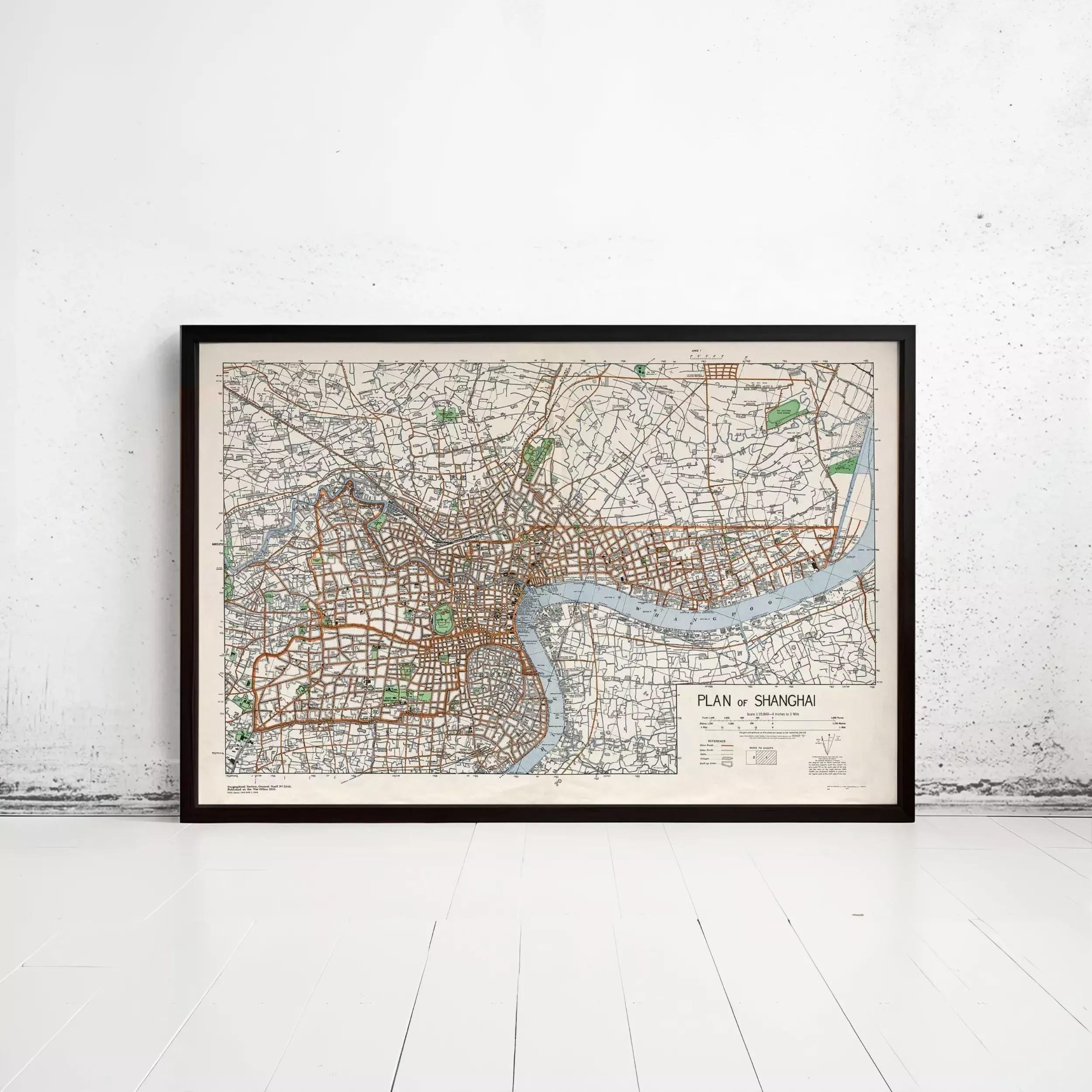 A framed map of Shanghai, China, with a river and various streets visible.