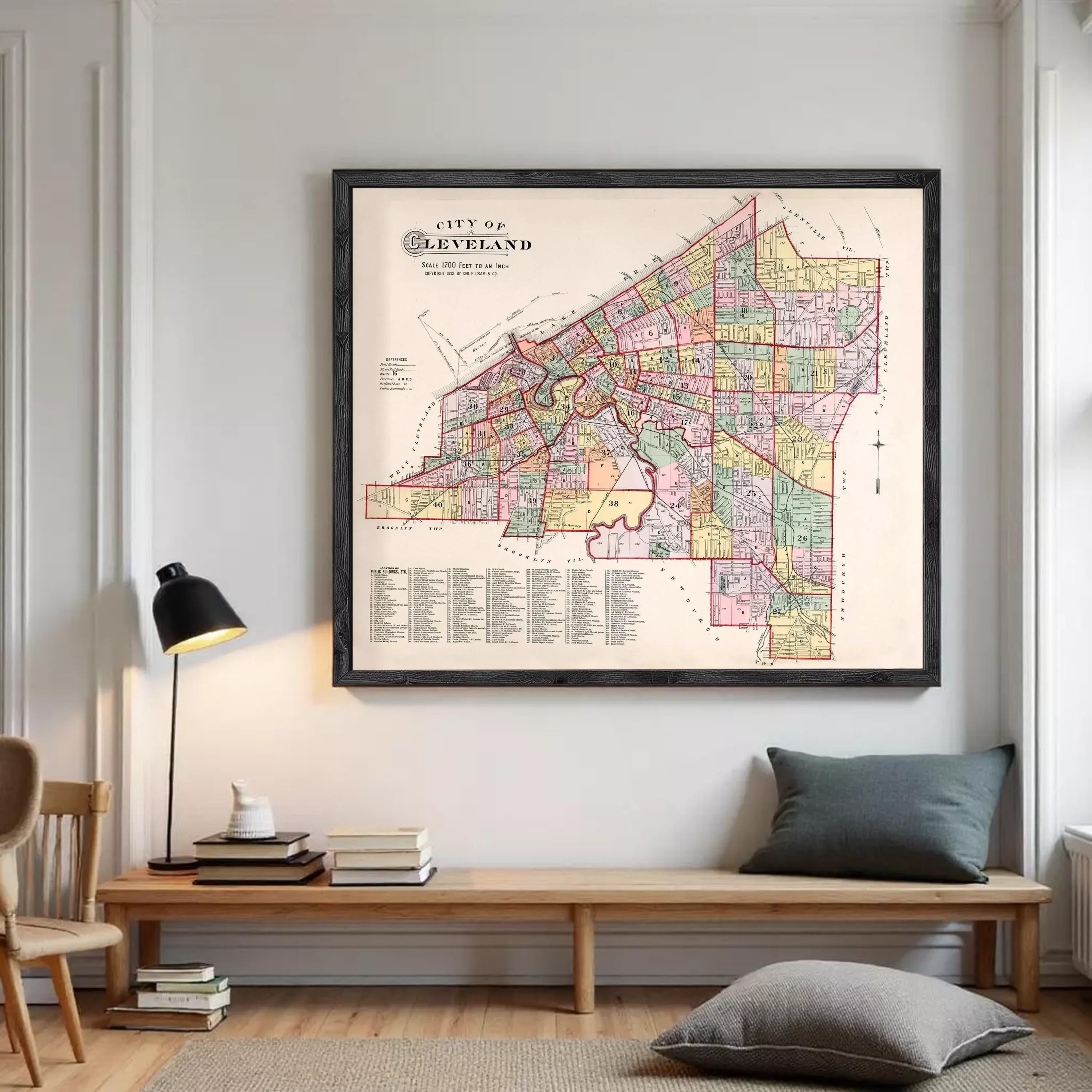 The image is a framed vintage map of Cleveland, Ohio, depicting the city's streets and neighborhoods in a detailed and colorful manner.