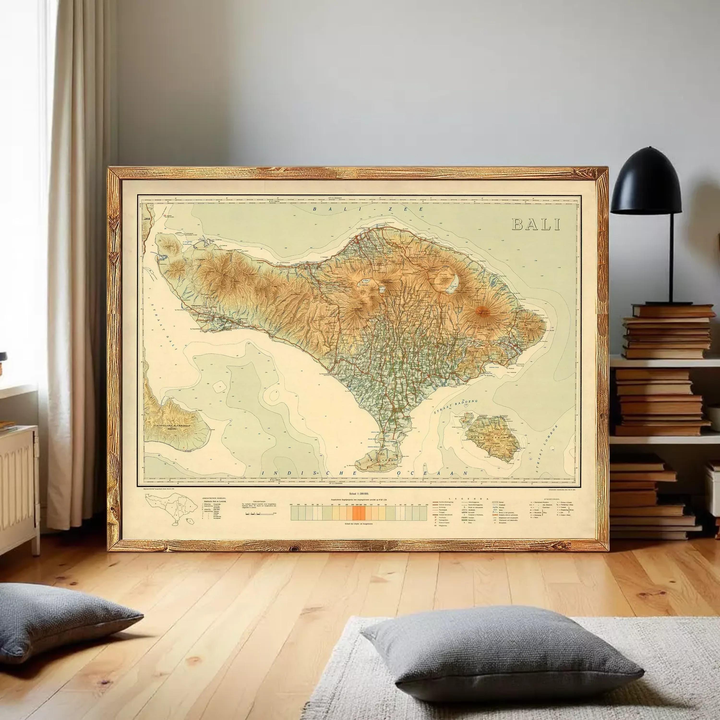 a large framed map of Bali, Indonesia, displayed on a wall in a room with a wooden floor and a bookshelf in the background.