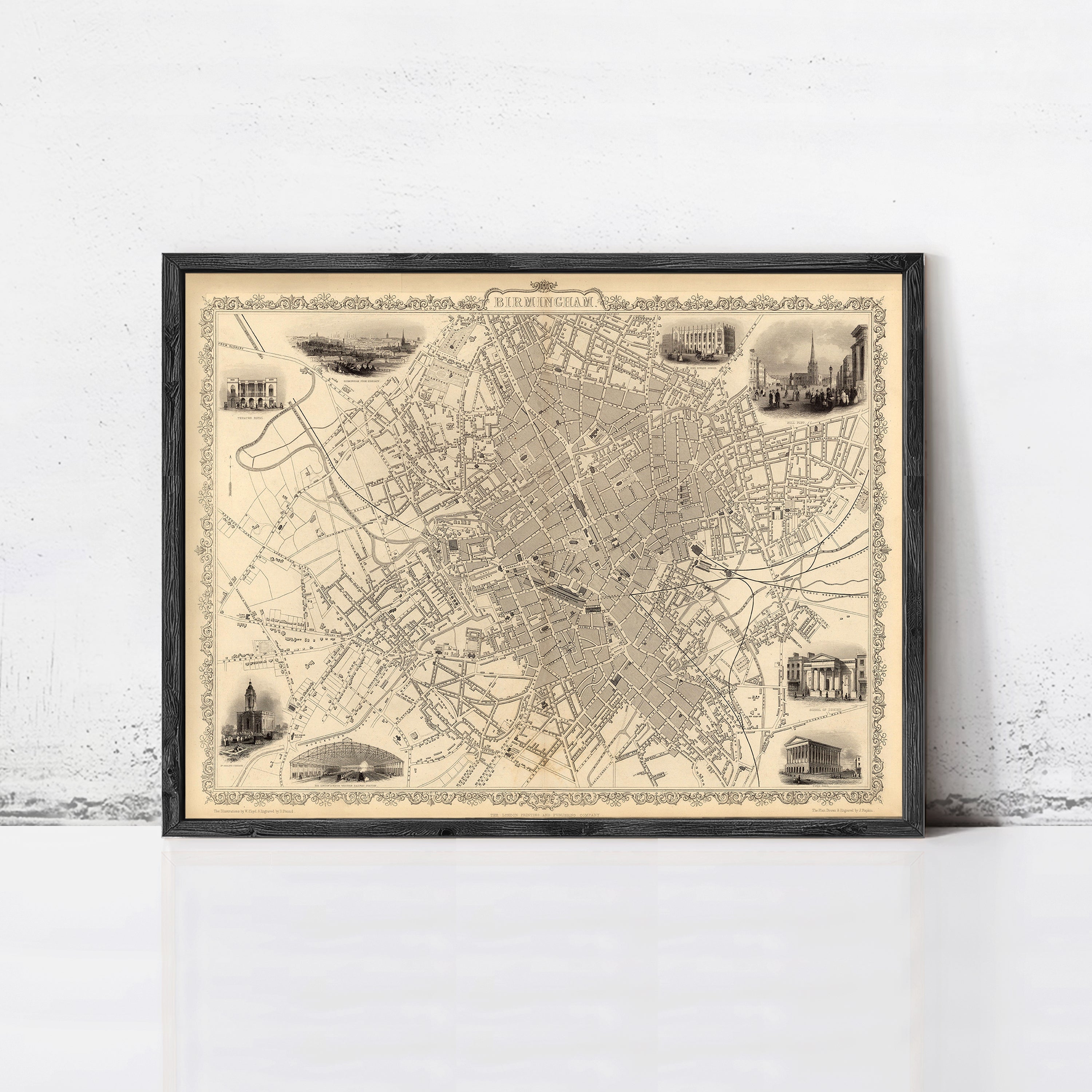 The image is a framed vintage map of a city, likely London, with various landmarks and streets depicted in black and white.