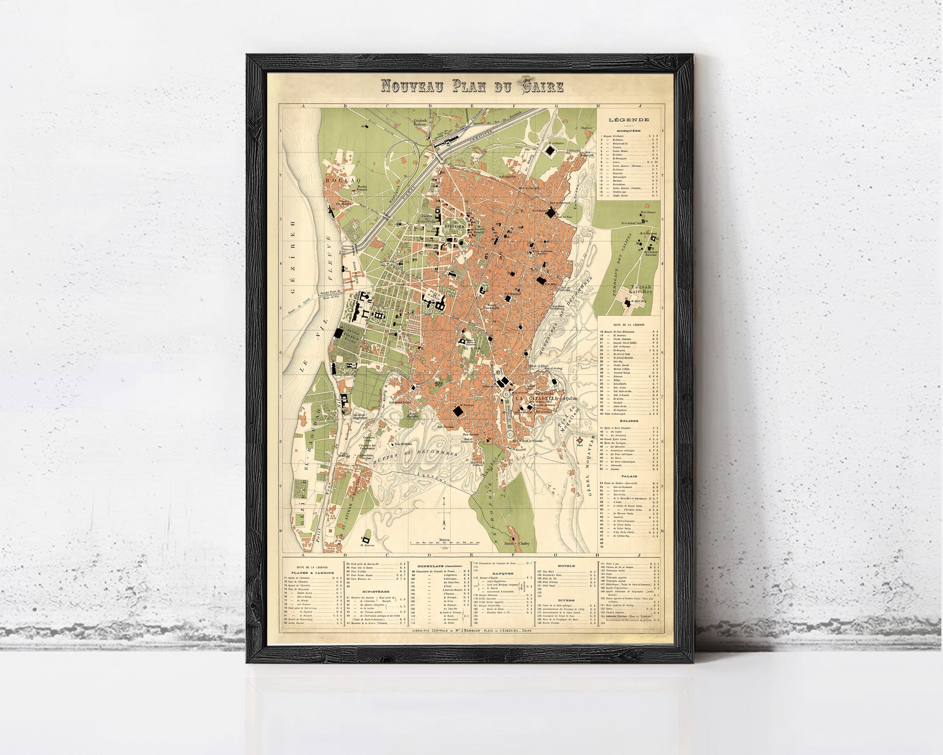 The image is a framed vintage map of a city, likely from the 19th century, with detailed geographical information and labels.