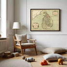 a cozy living room with a large framed map of Sri Lanka hanging on the wall. The room has a wooden chair, a lamp, and a stack of books on the floor. There are also some toys scattered around the room, adding a playful touch to the space.