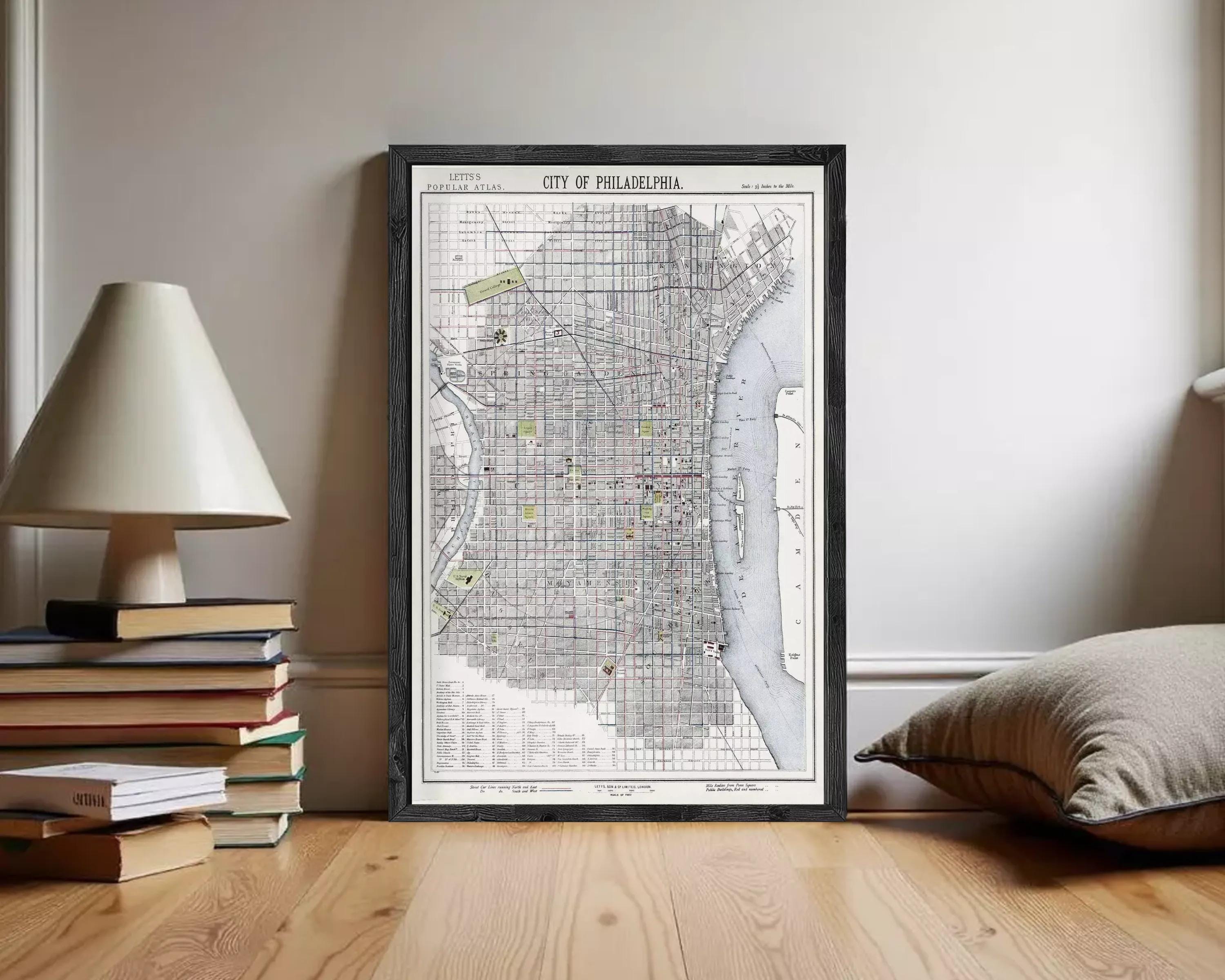 The image is a framed map of Philadelphia, Pennsylvania, depicting the city's streets, landmarks, and surrounding areas.