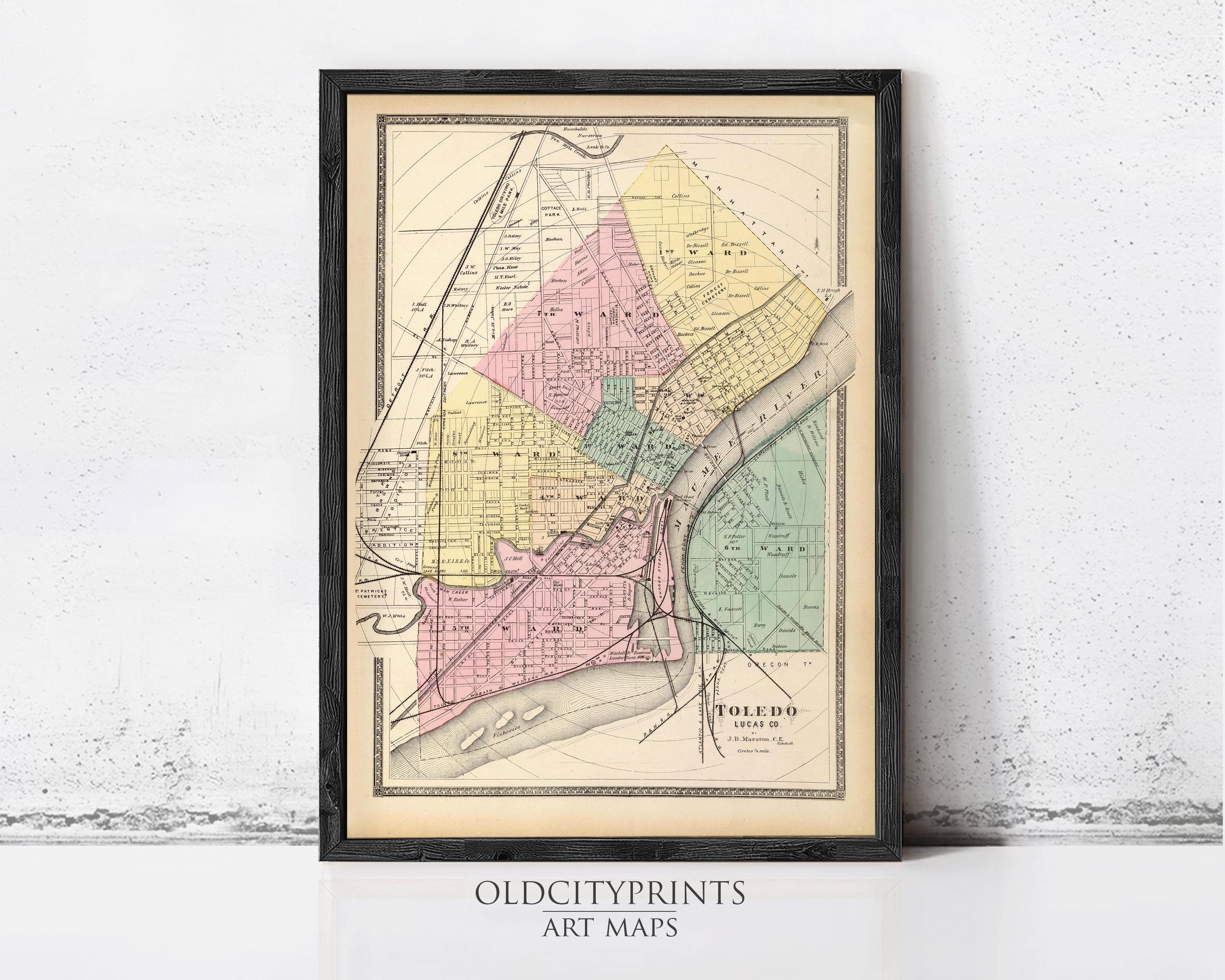 The image is a framed vintage map of the city of Toledo, Ohio, depicting the city's streets and neighborhoods in a detailed and colorful manner.