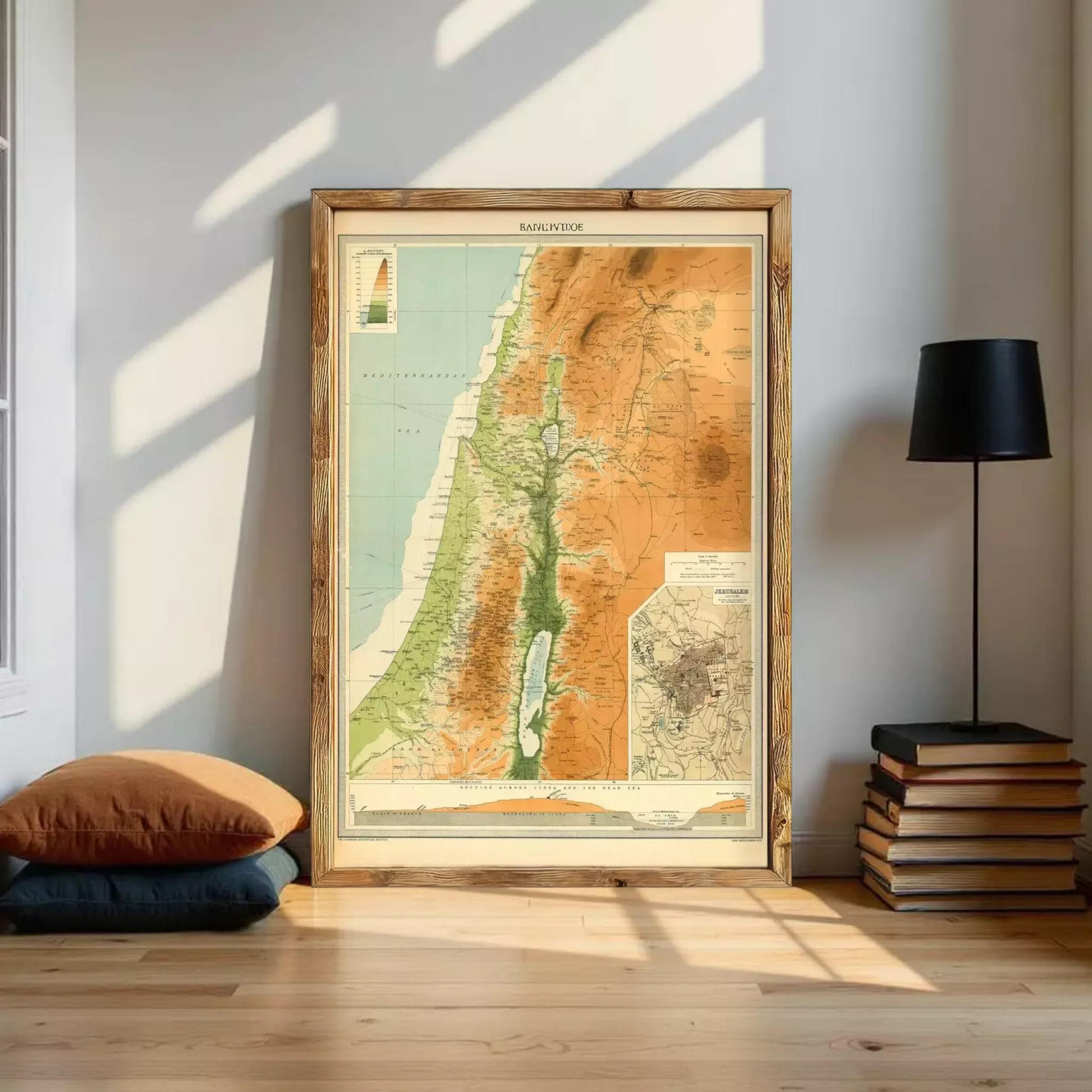 a large framed map of the Middle East, with a wooden frame and a black lamp on a shelf next to it.