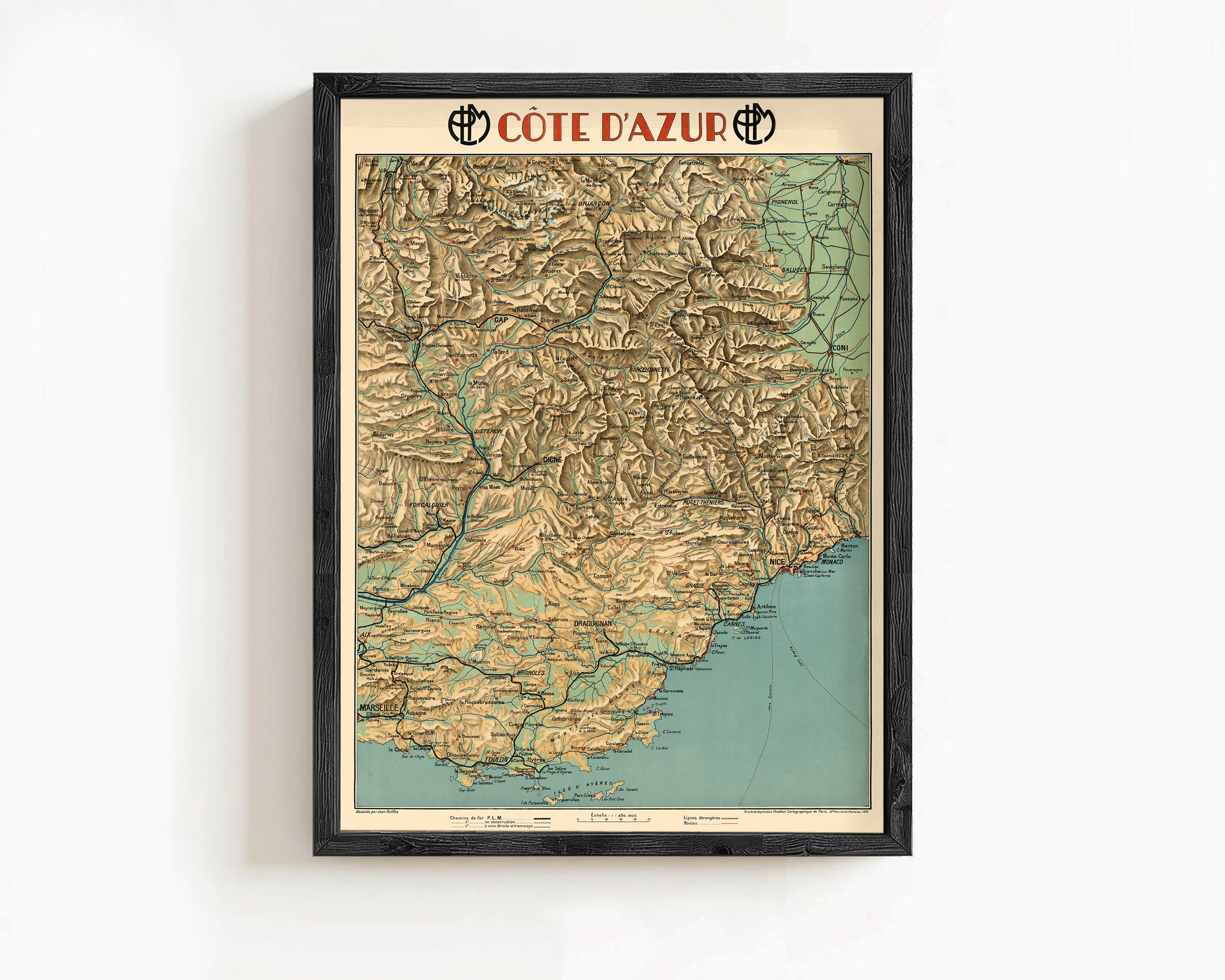 The image is a framed vintage map of the Cote d'azur region, depicting the area's mountainous terrain and coastline.