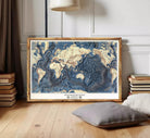 The image is a framed map of the world, specifically depicting the floor of the oceans.
