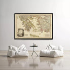 a large framed map of the world hanging on a white wall, with two white bean bag chairs positioned in front of it.