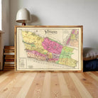The image is a framed vintage map of New York, depicting the city in a colorful and detailed manner.
