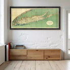 a large framed map of the United States hanging on a wall above a wooden cabinet or shelf.
