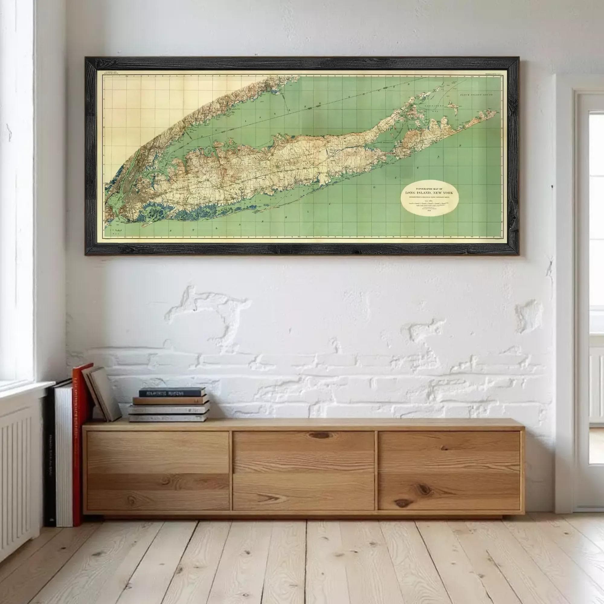 a large framed map of the United States hanging on a wall above a wooden cabinet or shelf.