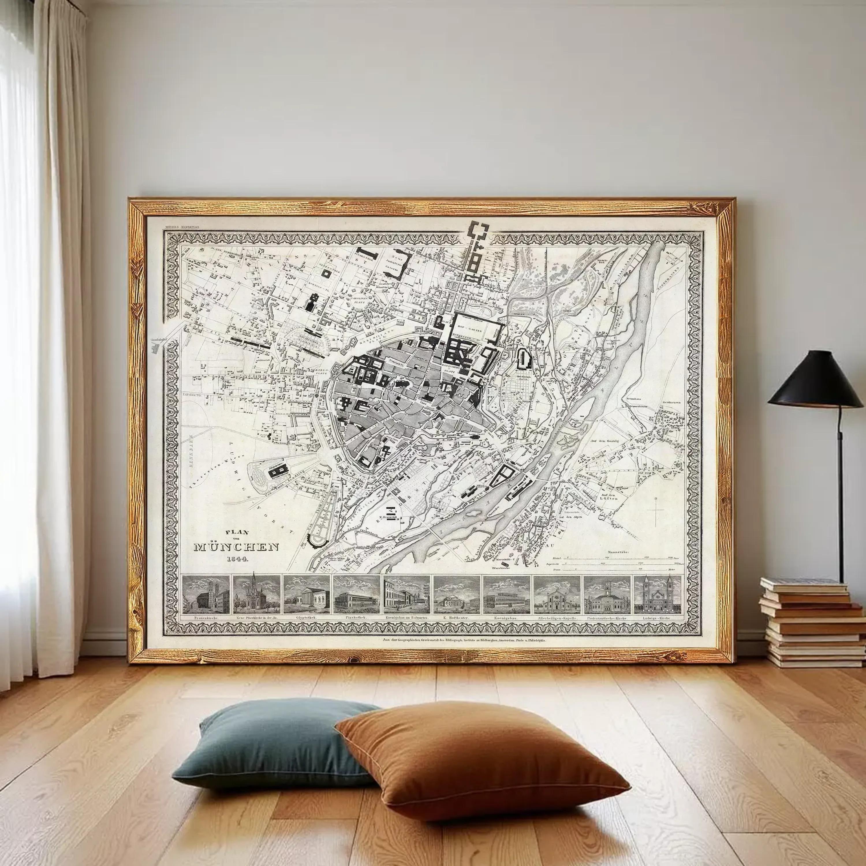 a large framed map of a city, with a wooden floor and a stack of books in the foreground.