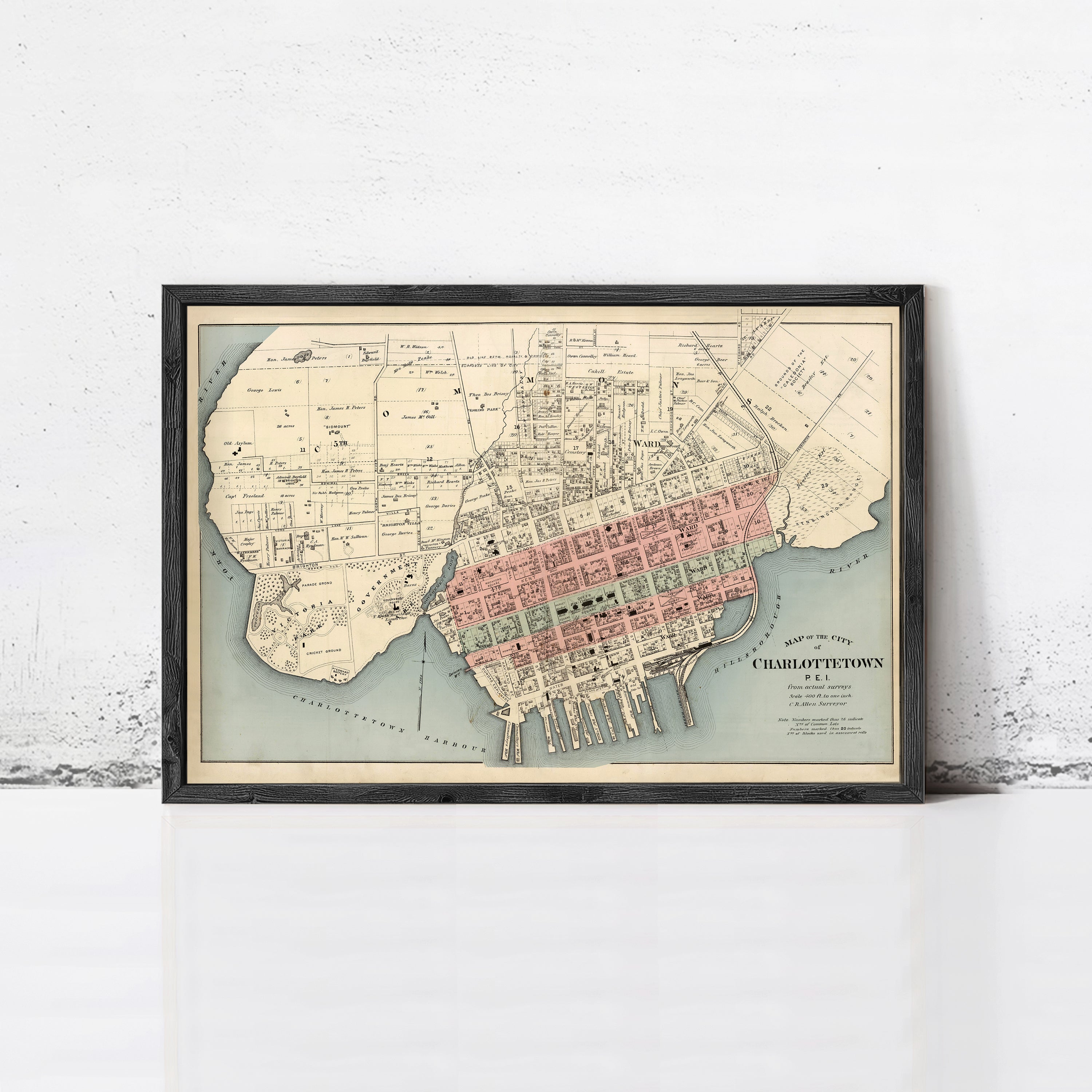 The image is a framed vintage map of the city of Charlottetown, showing the layout of the city and surrounding areas.