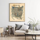 a large framed map of New York hanging on a wall in a living room setting.
