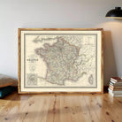 The image is a framed vintage map of France, depicting the country's geographical layout and major cities.