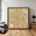 The image is a framed vintage map of a city, depicting a detailed layout of streets, buildings, and other urban features.