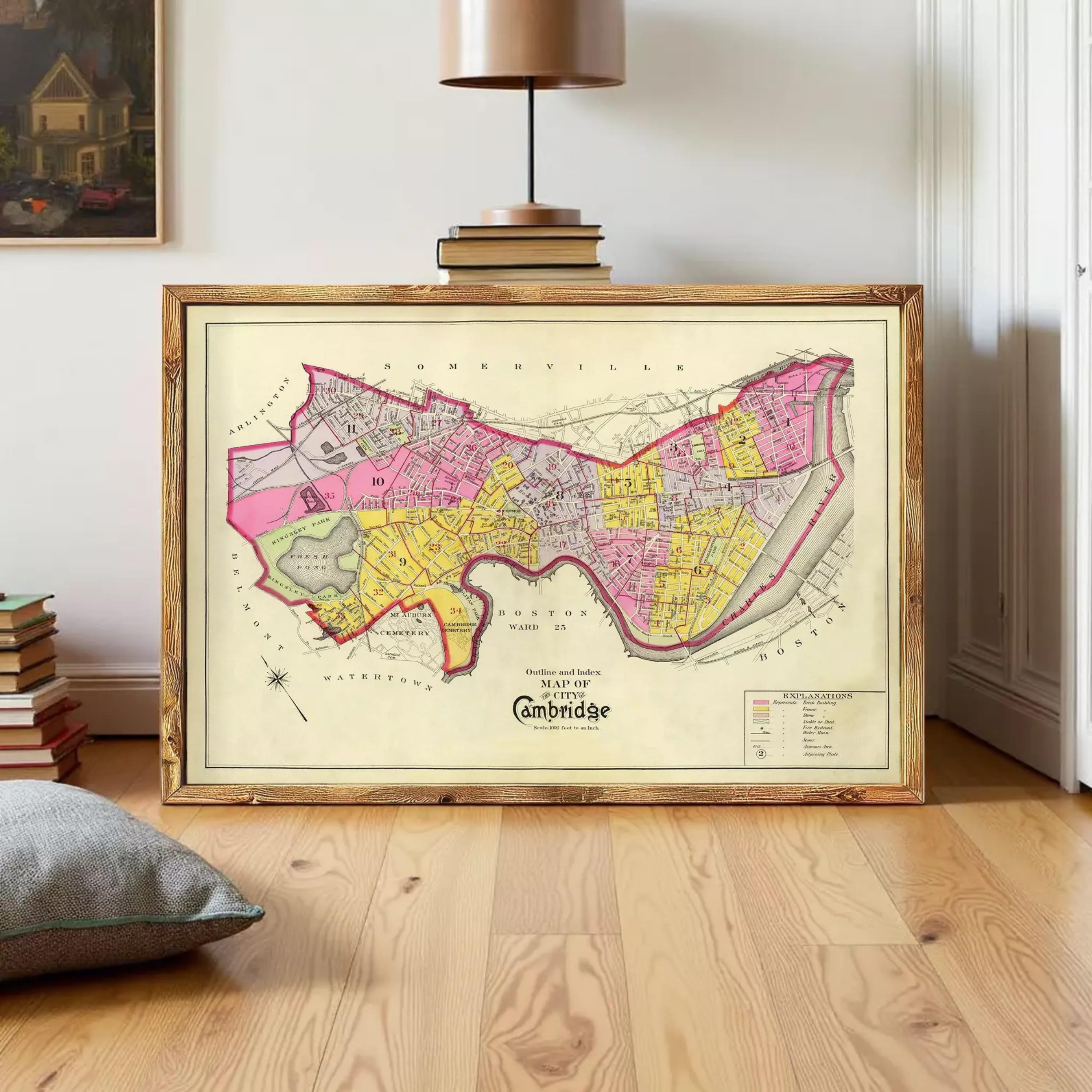 The image is a framed map of Cambridge, England, showing the city's streets and surrounding areas.
