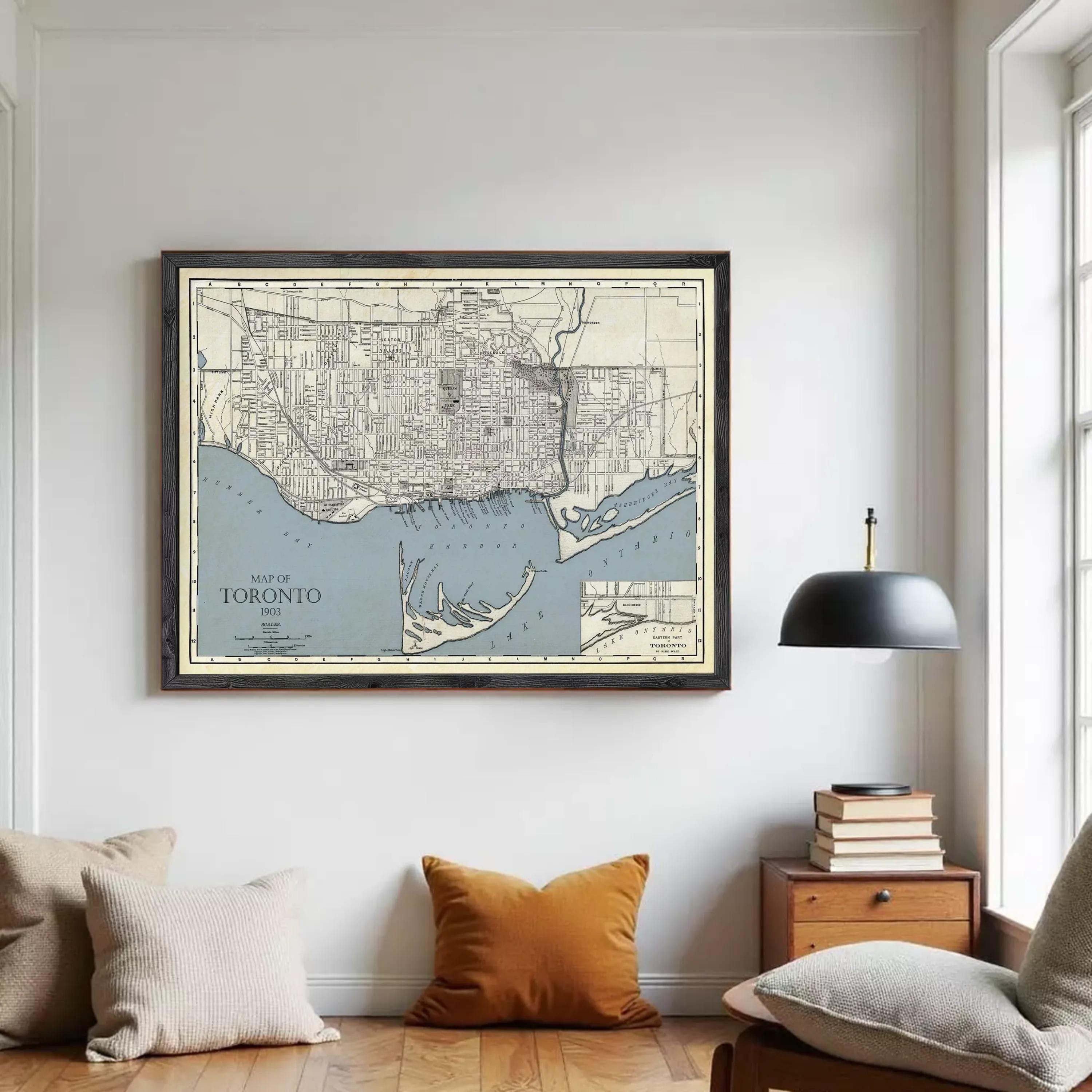A framed vintage map of Toronto, Canada, depicting the city's streets and surrounding areas.