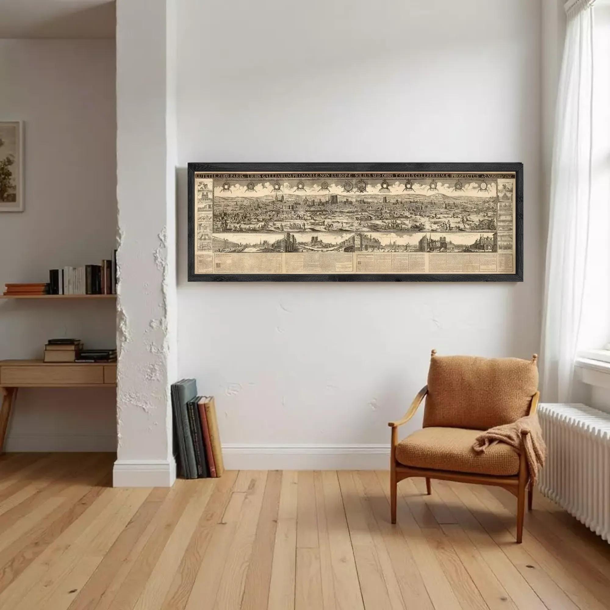 a large framed map of a city hanging on a white wall in a room with a wooden floor.