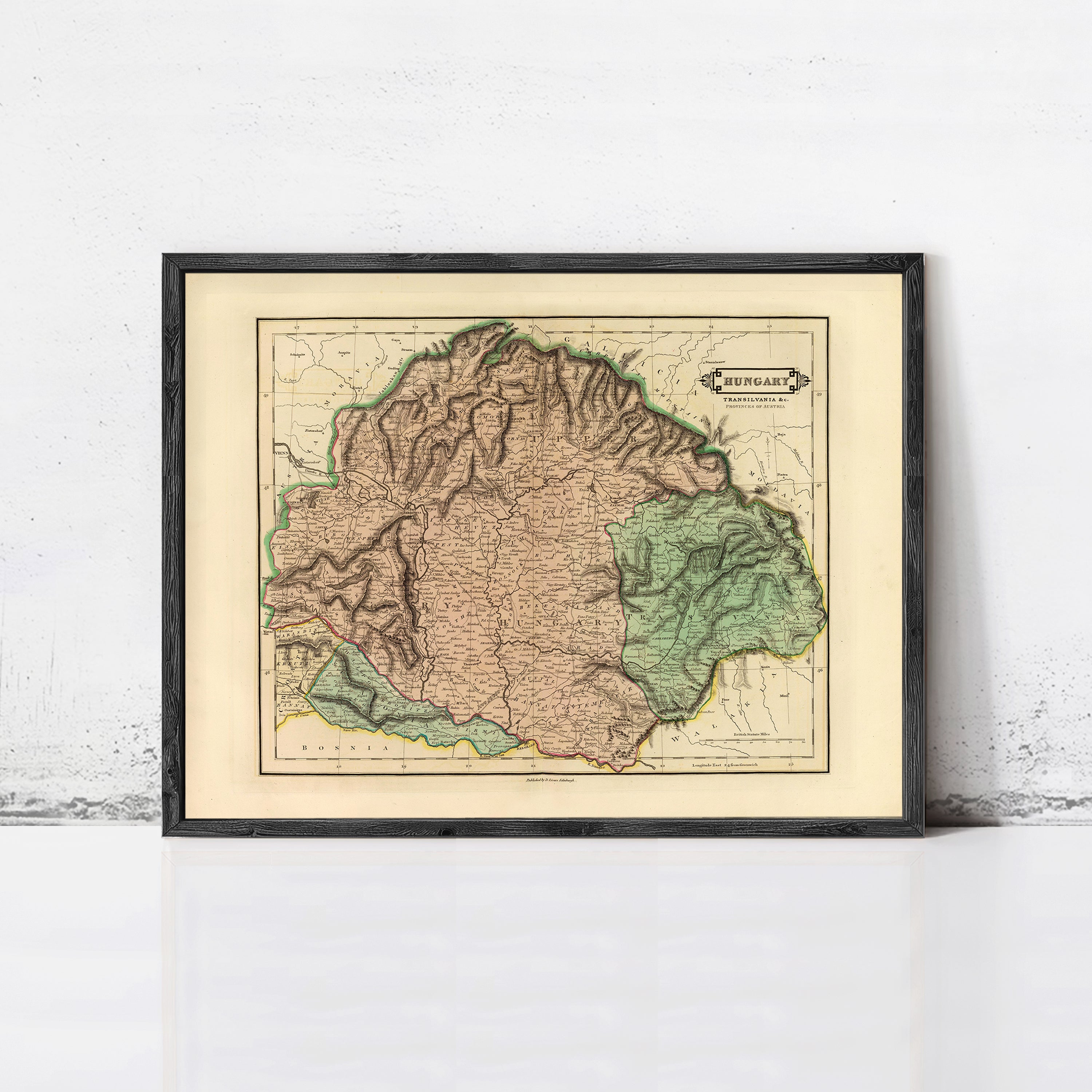 The image is a framed map of Hungary, depicting the country's geographical layout and boundaries.
