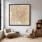 a large framed map of Florence, Italy, hanging on a wall in a room with two armchairs and a small side table.
