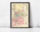 The image is a framed vintage map of a city, likely from the late 19th century, depicting the layout and boundaries of the city.