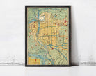 The image is a framed map of a city, likely from the 19th century, with various landmarks and streets depicted in a stylized manner.
