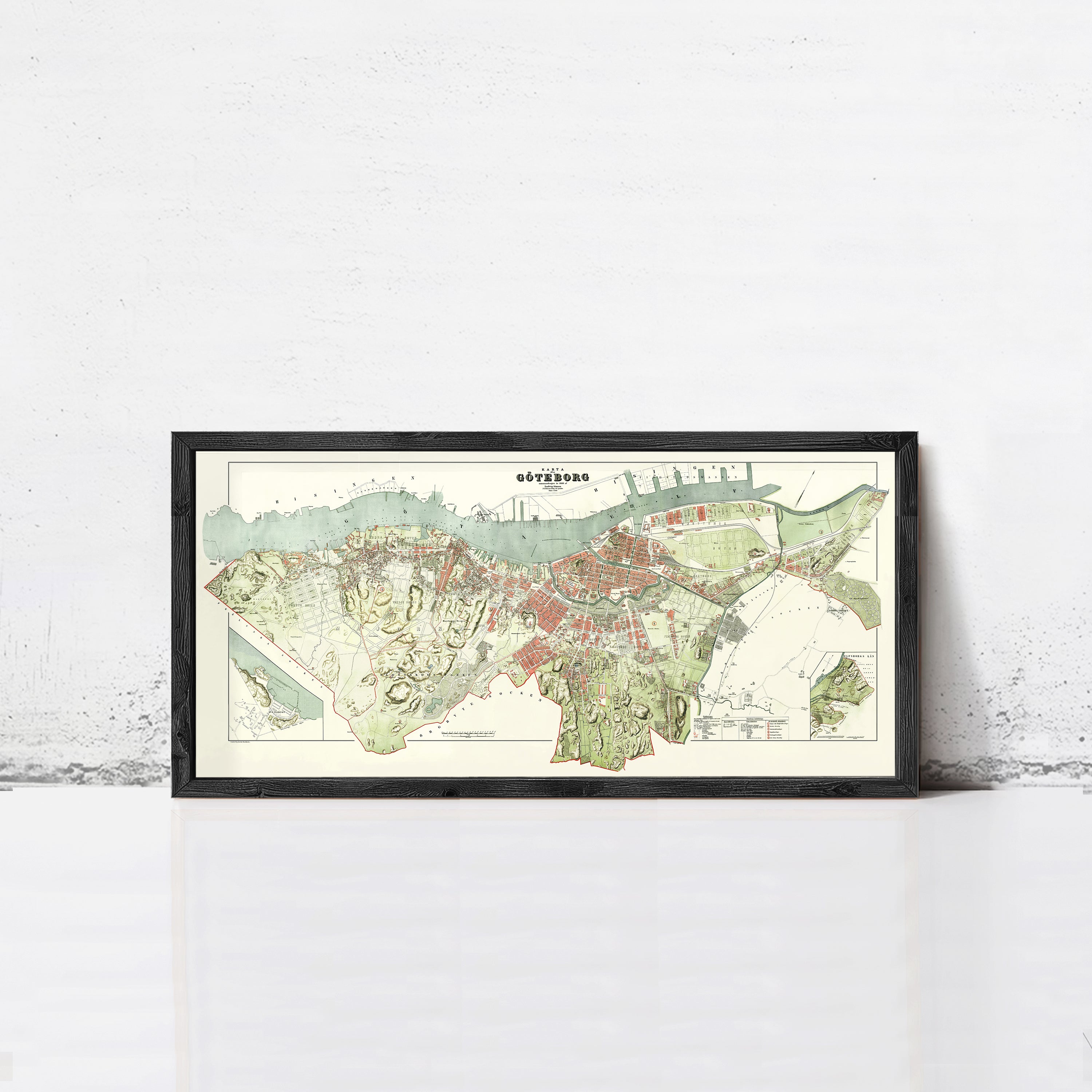 The image is a framed map of a city, likely a historical or geographical map, displayed on a white wall.