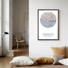 a framed map of Toronto, Canada, hanging on a wall in a living room setting.