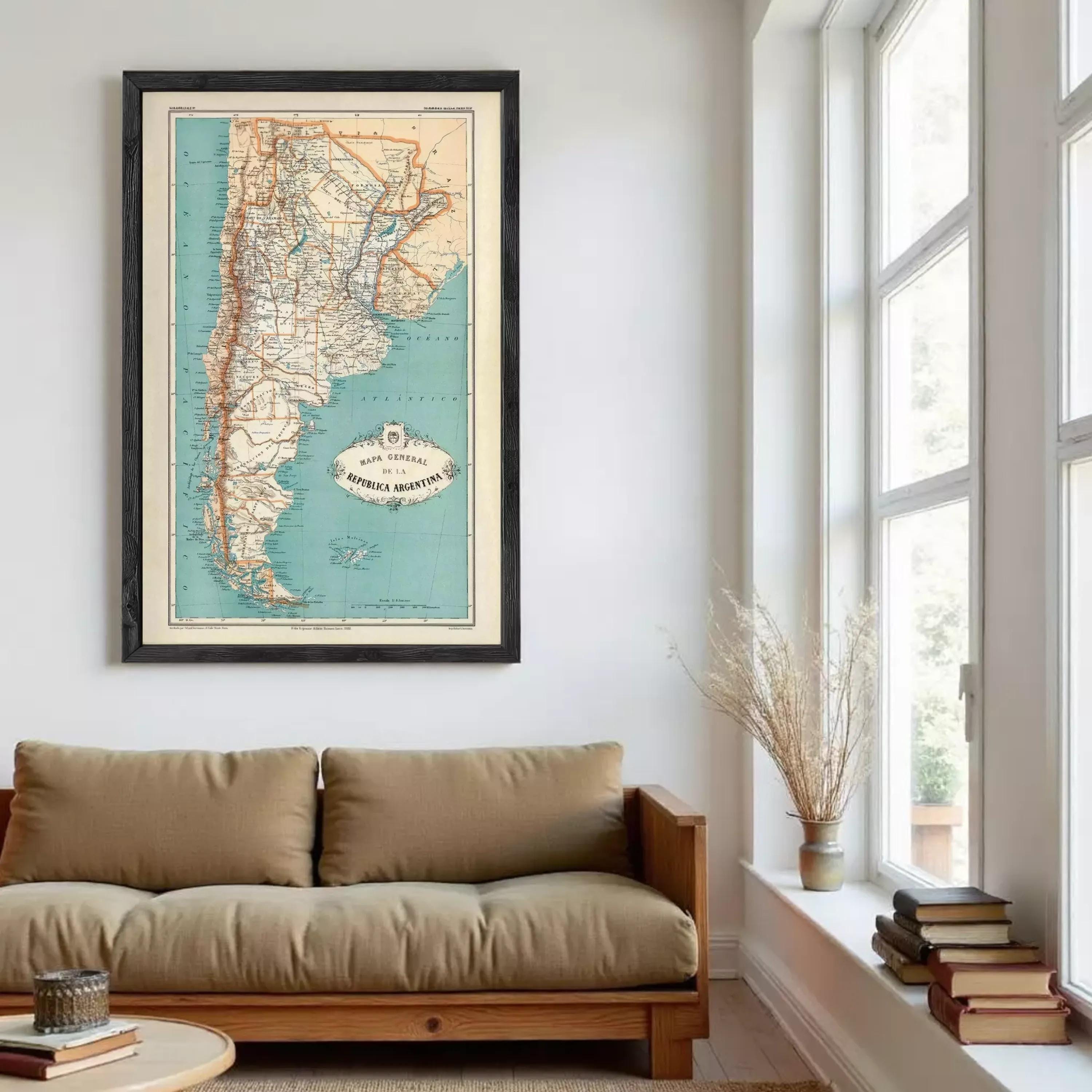 a framed map of Chile hanging on a wall in a living room.