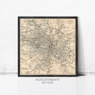 The image is a framed vintage map of Glasgow, Scotland, depicting the city's streets and landmarks in a detailed and intricate manner.