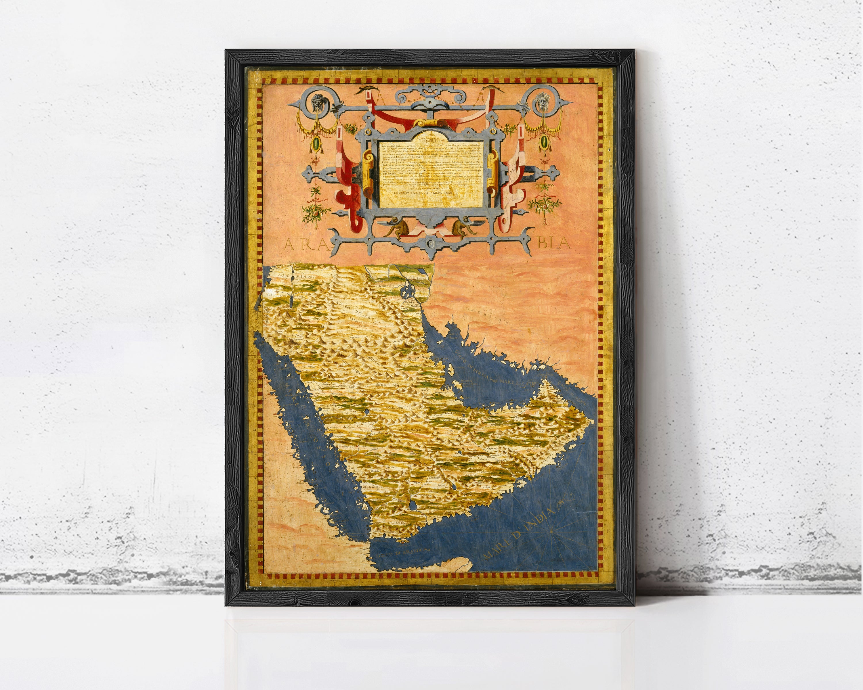 The image is a framed painting depicting a map of the Middle East, with a decorative border and ornate design elements.