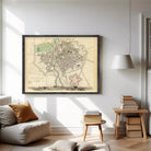The image is a framed vintage map of a city, depicting a detailed layout of the streets, buildings, and other urban features.