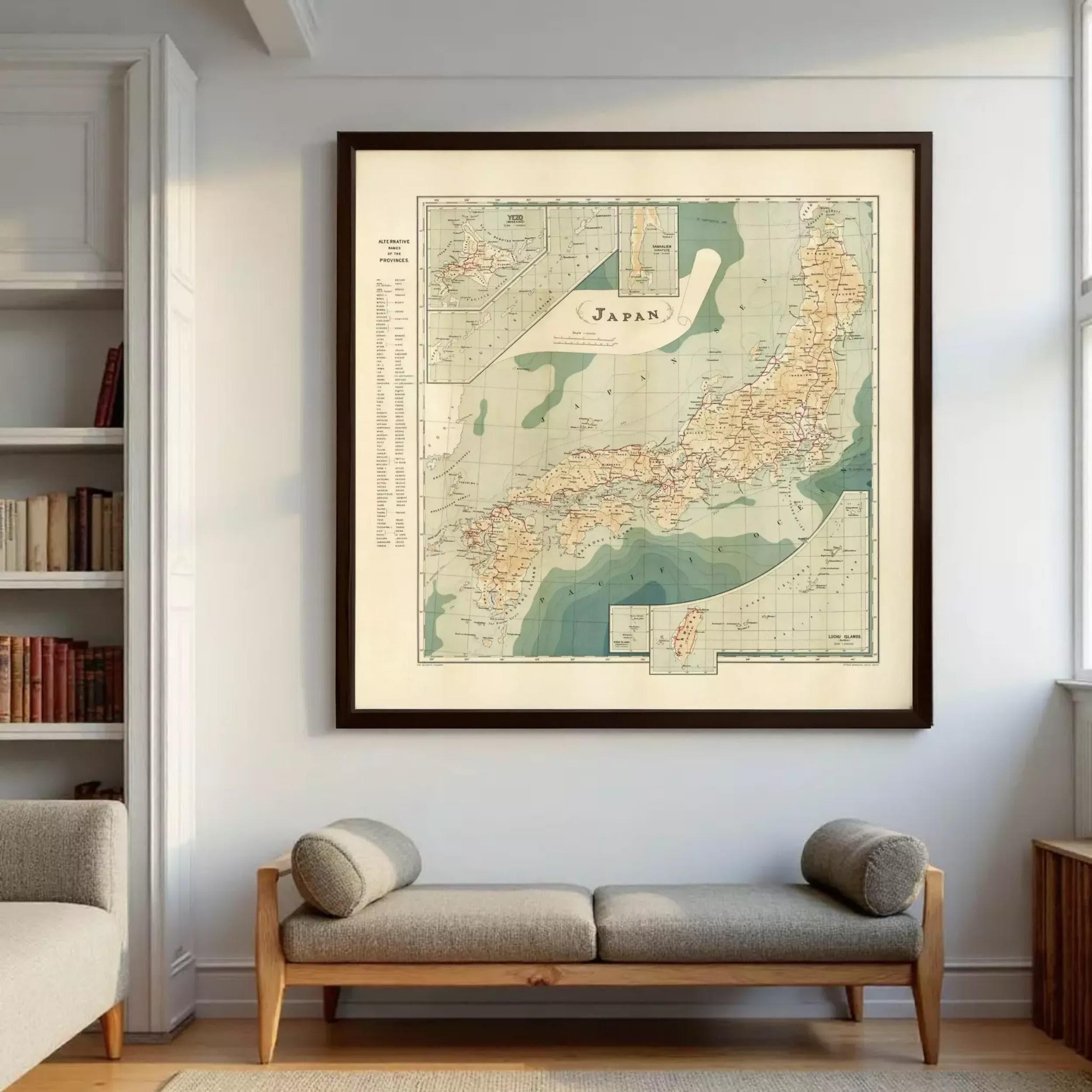 a large framed map of Japan hanging on a wall, with a bookshelf and a bench below it.