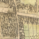 The image is a detailed map of a city, showing various buildings, streets, and other urban elements. The map appears to be old and possibly hand-drawn, with intricate architectural details and a vintage style.
