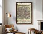 The image is a framed vintage map of a city, likely Paris, with intricate details and a detailed layout.
