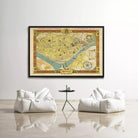 a large framed map of a city hanging on a wall, with two white bean bag chairs positioned in front of it.