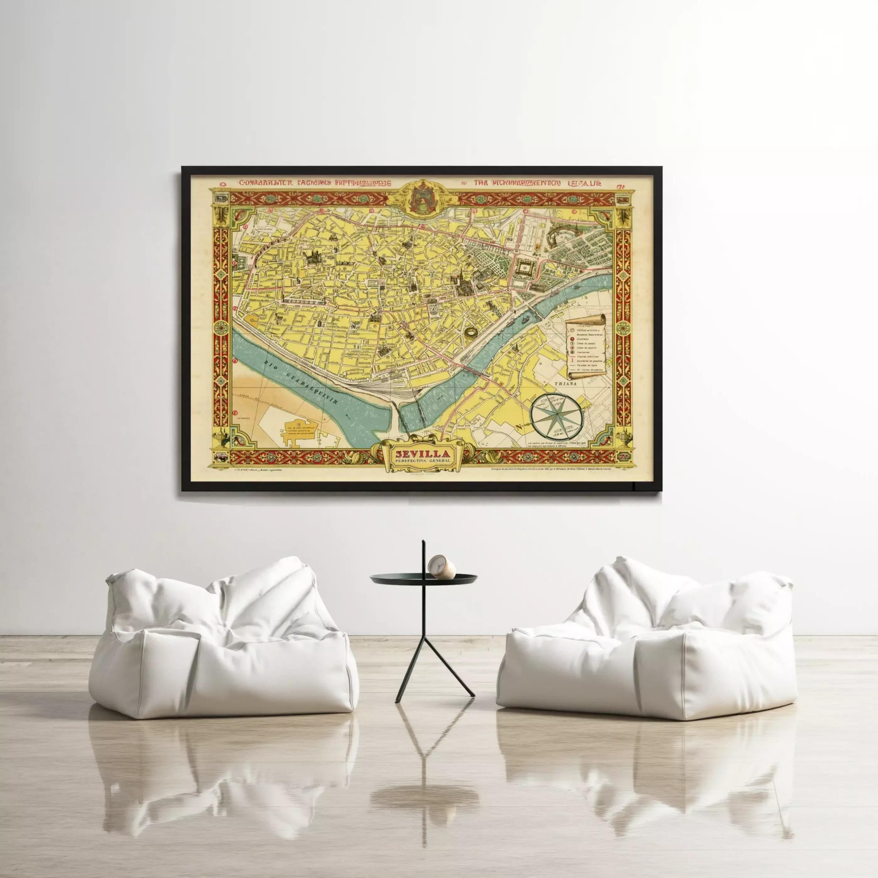 a large framed map of a city hanging on a wall, with two white bean bag chairs positioned in front of it.