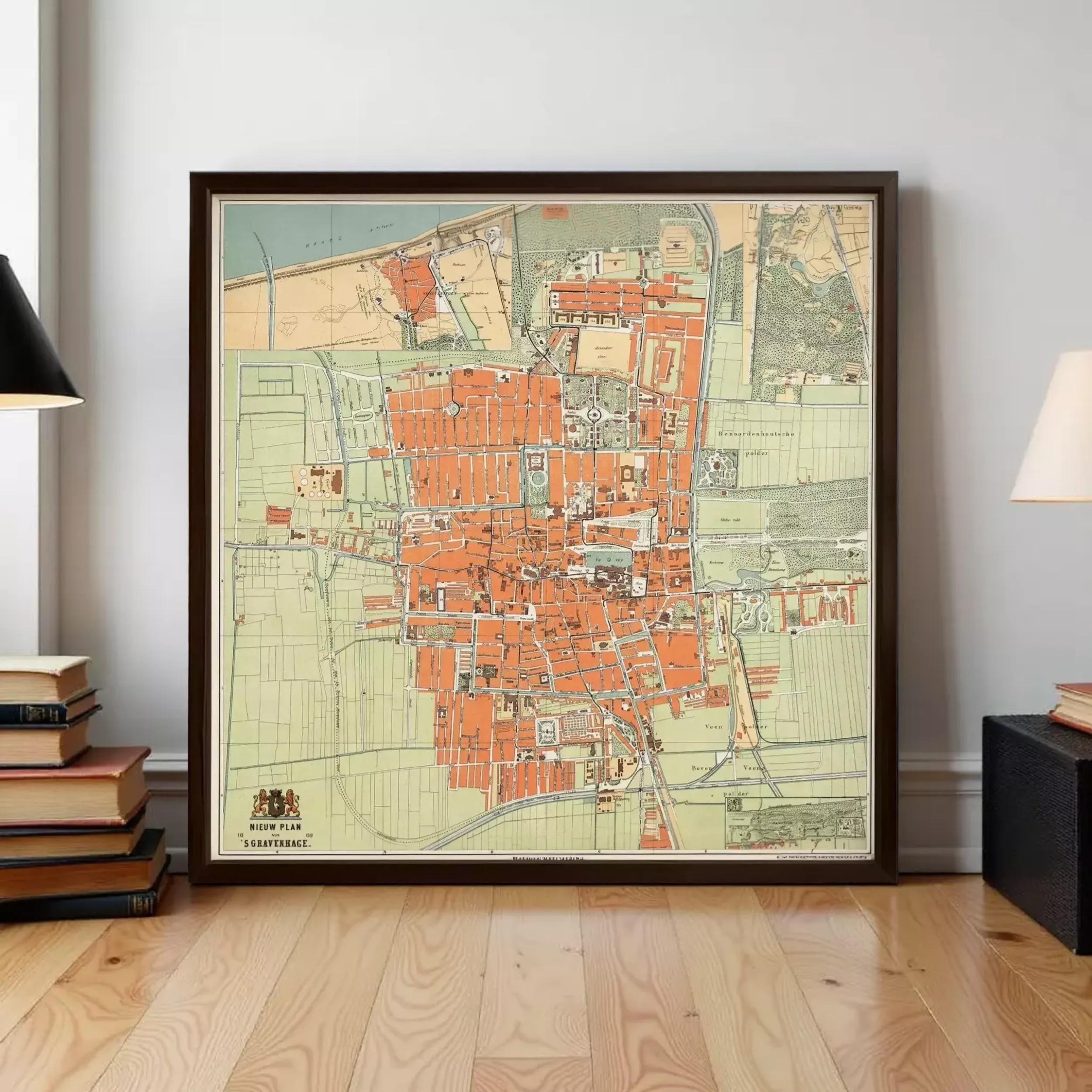 The image is a large framed map of a city, likely from the 19th century, displayed on a wall in a room.