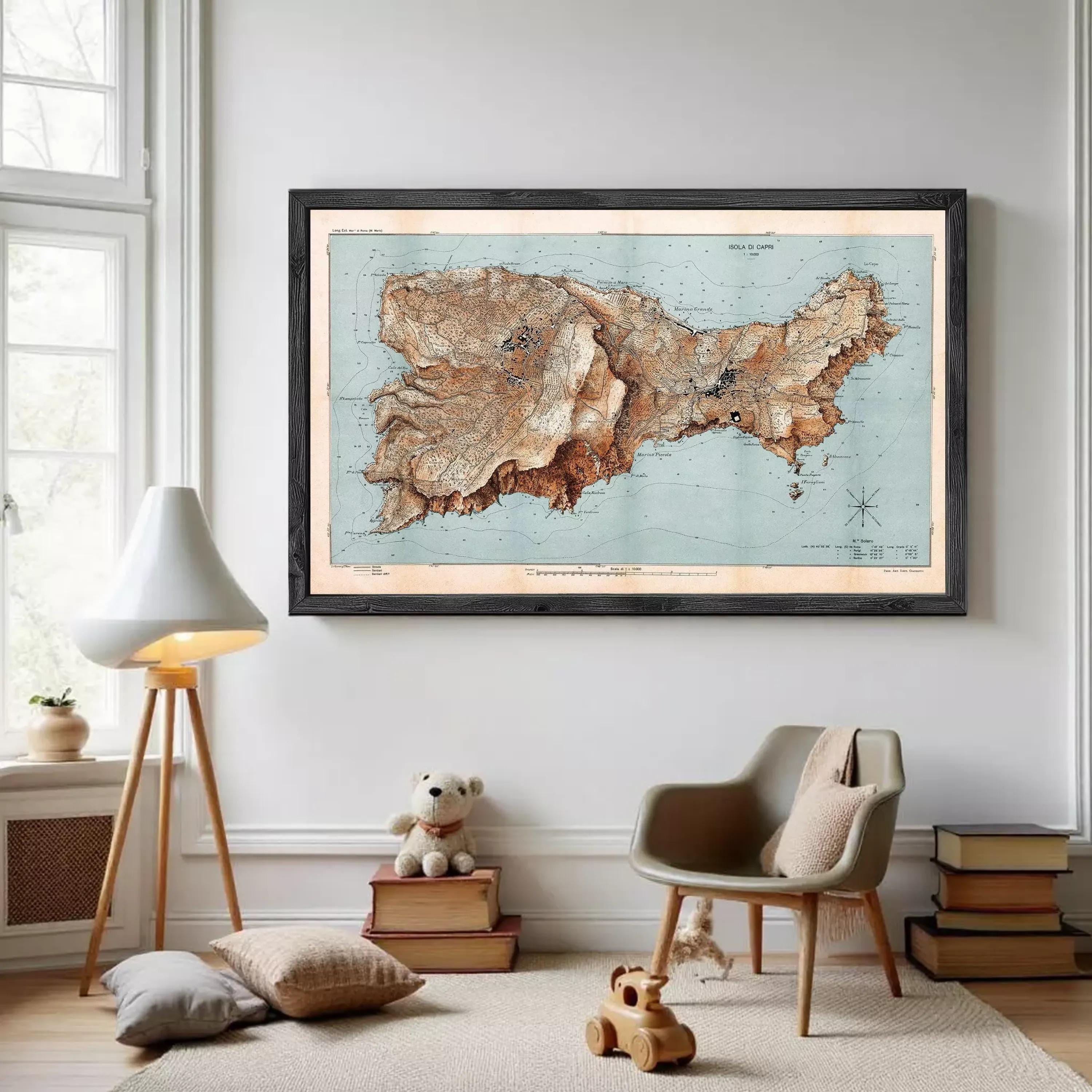 a large framed map of a region hanging on a wall, with a lamp, a teddy bear, and a stack of books in the foreground.