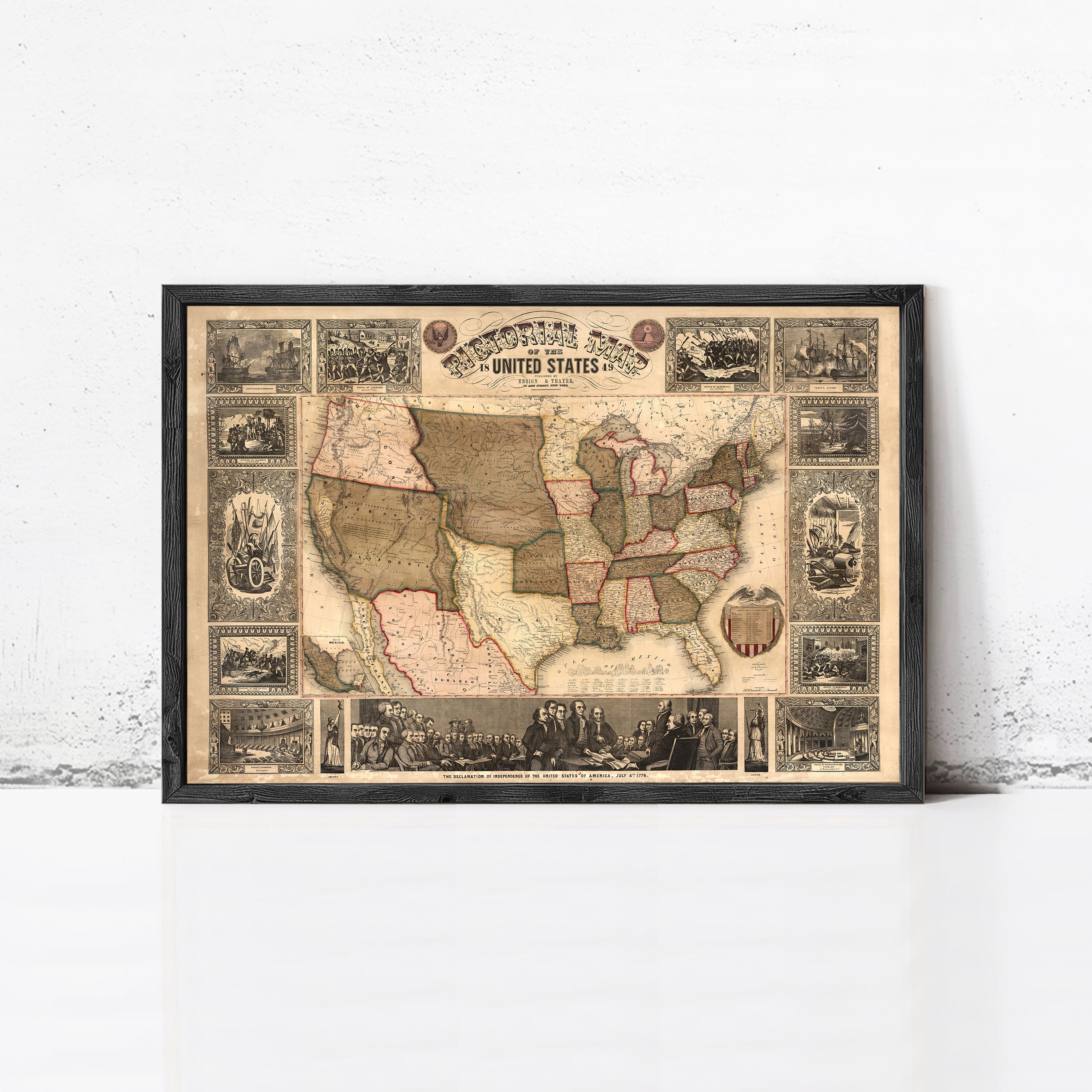 The image is a framed vintage map of the United States, depicting various scenes and landmarks across the country.