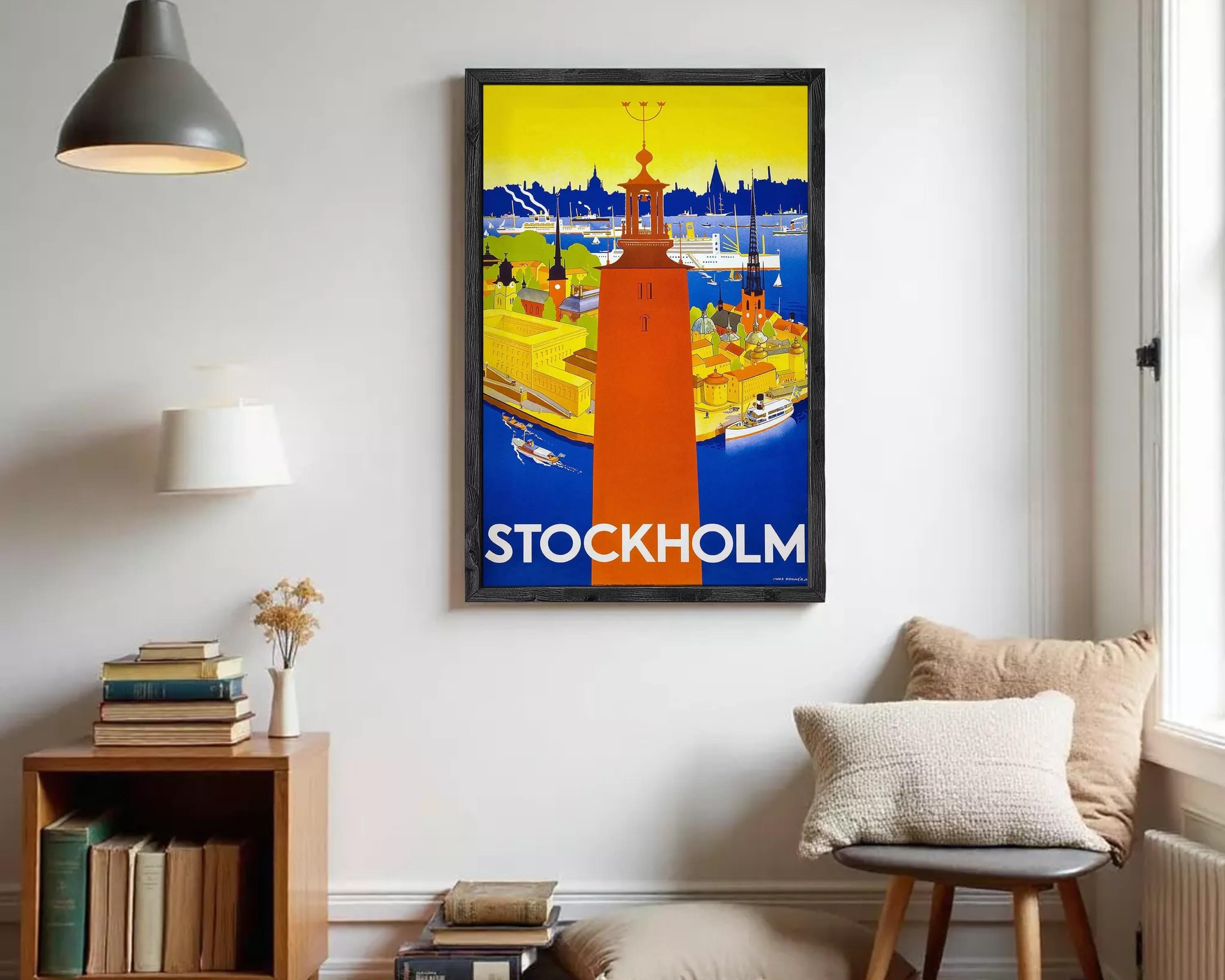 A framed poster of a cityscape with a tall tower in the center, surrounded by various buildings and boats. The text "STOCKHOLM" is prominently displayed at the bottom of the poster.