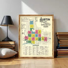 The image is a framed vintage map of Austin, Texas, showing the city's layout and various landmarks.