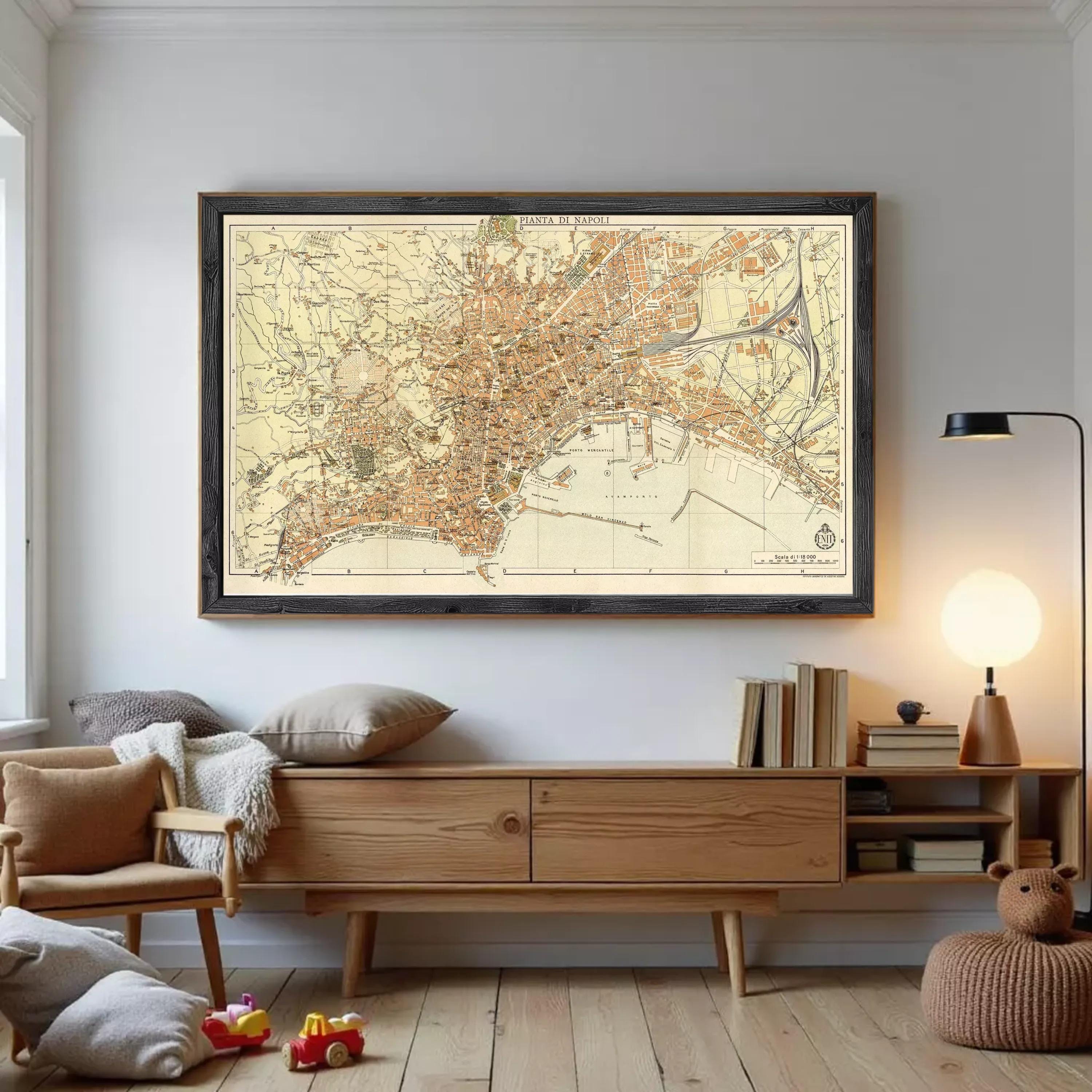 a large framed map of Paris hanging on a wall, with a wooden cabinet below it and a cozy reading nook with a lamp and books nearby.