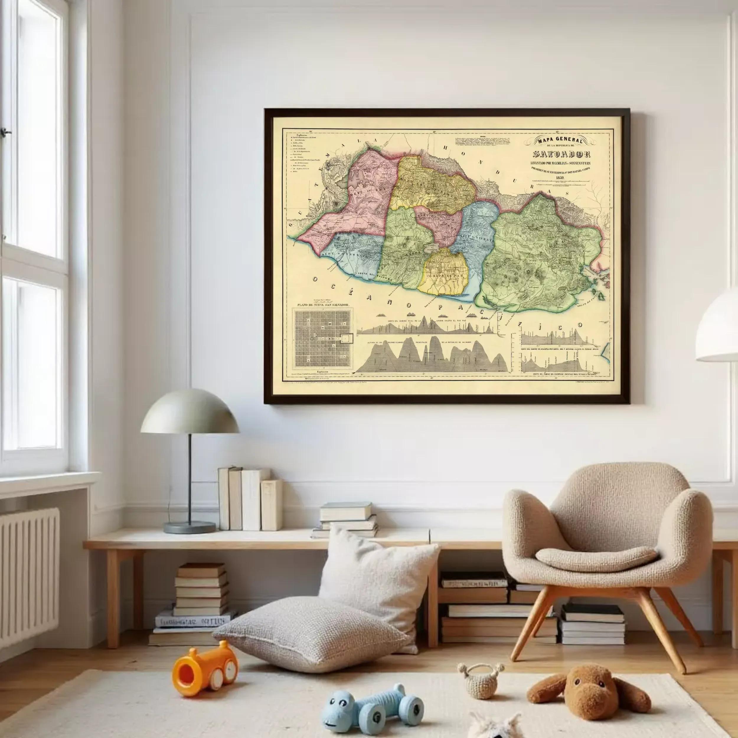 a large framed map of a region hanging on a wall in a room with a wooden floor, a beige armchair, and a small table with a lamp.
